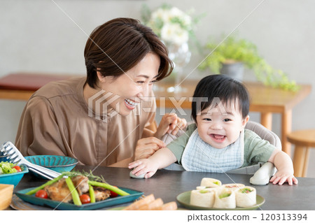 Mom and baby eating 120313394