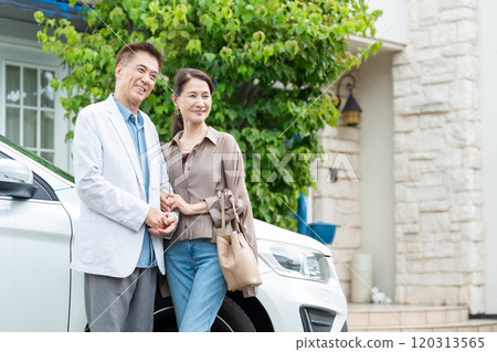 A middle-aged couple driving 120313565