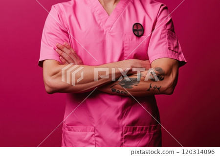Doctor wearing pink scrubs and crossing arms on pink background 120314096