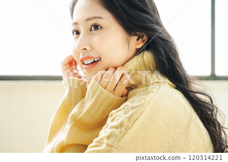 Young woman wearing a knitted sweater Young woman wearing a knitted sweater 120314221