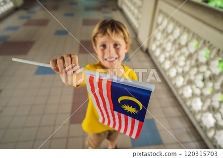 Boy travels in malaysia with malaysia flag celebrating the Malaysia independence day and Malaysia day. Travel to Malaysia concept 120315703