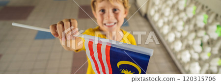 Boy travels in malaysia with malaysia flag celebrating the Malaysia independence day and Malaysia day. Travel to Malaysia concept BANNER, LONG FORMAT Boy travels in malaysia with malaysia flag celebrating the Malaysia independence day and Malaysia day. Travel to Malaysia concept BANNER, LONG FORMAT 120315706