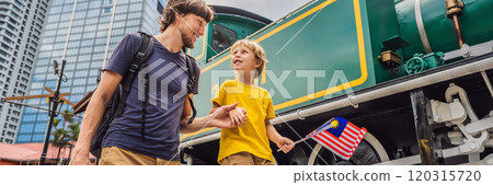 Father and son travelers in malaysia with malaysia flag celebrating the Malaysia independence day and Malaysia day. Travel to Malaysia concept BANNER, LONG FORMAT 120315720