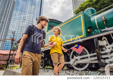 Father and son travelers in malaysia with malaysia flag celebrating the Malaysia independence day and Malaysia day. Travel to Malaysia concept 120315721