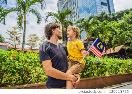Father and son travelers in malaysia with malaysia flag celebrating the Malaysia independence day and Malaysia day. Travel to Malaysia concept Father and son travelers in malaysia with malaysia flag celebrating the Malaysia independence day and Malaysia day. Travel to Malaysia concept 120315725