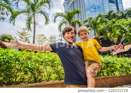 Father and son travelers in malaysia with malaysia flag celebrating the Malaysia independence day and Malaysia day. Travel to Malaysia concept 120315729
