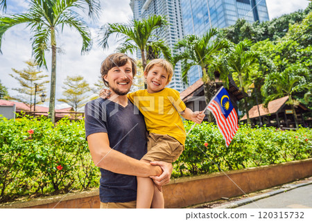 Father and son travelers in malaysia with malaysia flag celebrating the Malaysia independence day and Malaysia day. Travel to Malaysia concept Father and son travelers in malaysia with malaysia flag celebrating the Malaysia independence day and Malaysia day. Travel to Malaysia concept 120315732