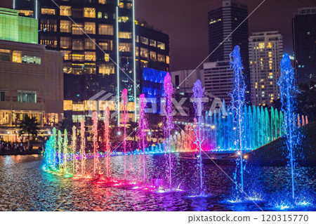 The colorful fountain on the lake at night, near by Twin Towers with city on background. Kuala Lumpur, Malaysia The colorful fountain on the lake at night, near by Twin Towers with city on background. Kuala Lumpur, Malaysia 120315770