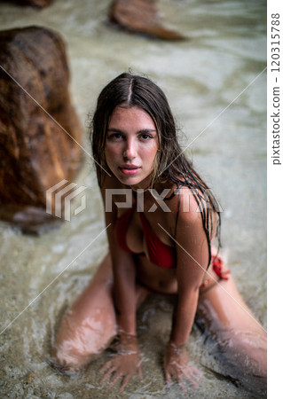 A Relaxing Woman in a Bikini Enjoying Her Time by the Beautiful Beach and Ocean Waves 120315788