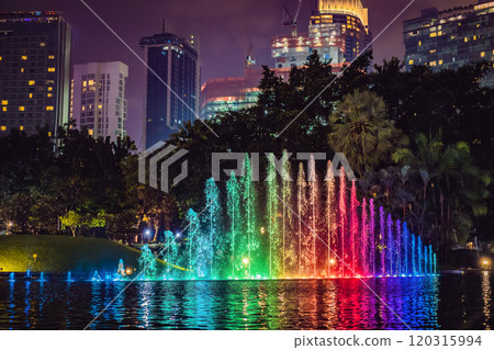 The colorful fountain on the lake at night with city on background. Kuala Lumpur, Malaysia The colorful fountain on the lake at night with city on background. Kuala Lumpur, Malaysia 120315994