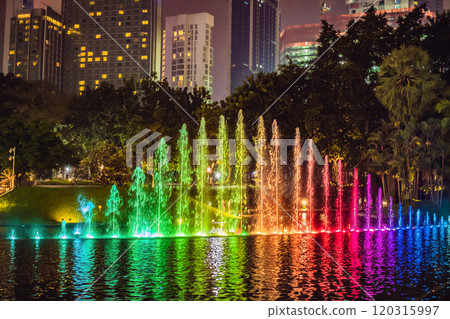 The colorful fountain on the lake at night, near by Twin Towers with city on background. Kuala Lumpur, Malaysia The colorful fountain on the lake at night, near by Twin Towers with city on background. Kuala Lumpur, Malaysia 120315997