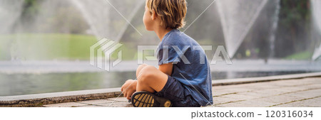 Boy on background of Fountain on the lake in the evening, near by Twin Towers with city on background. Kuala Lumpur, Malaysia BANNER, LONG FORMAT 120316034
