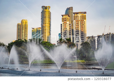 Fountain on the lake in the evening, near by Twin Towers with city on background. Kuala Lumpur, Malaysia Fountain on the lake in the evening, near by Twin Towers with city on background. Kuala Lumpur, Malaysia 120316077