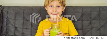 The boy is drinking Green tea latte with ice in mason jar. Homemade Iced Matcha Latte Tea with Milk zero waste BANNER, LONG FORMAT 120316166
