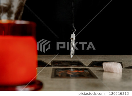 fortune teller predicting fate, reading tarot cards, pendulum.  120316213