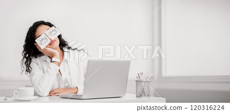 Insomnia. Lazy unproductive office worker girl wearing funny sticky notes on her eyes sleeping at workplace, copyspace Insomnia. Lazy unproductive office worker girl wearing funny sticky notes on her eyes sleeping at workplace, copyspace 120316224