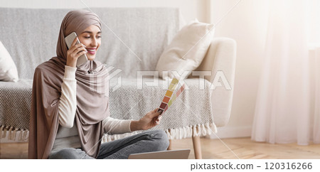 Young Arabic Girl In Headscarf Talking On Cellphone And Holding Color Palette, Consulting With Designer About Home Interior 120316266