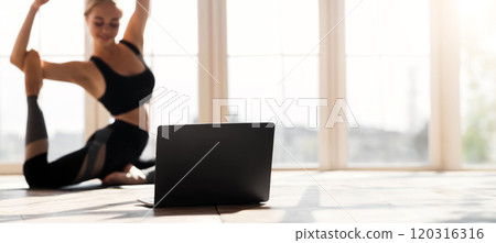 Sport, fitness application. Yoga girl exercising in front of laptop at home, selective focus, copy space Sport, fitness application. Yoga girl exercising in front of laptop at home, selective focus, copy space 120316316