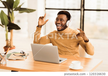 Life Is Good. Cheerful black student listening to favorite music in headphones at office, singing and dancing, free space Life Is Good. Cheerful black student listening to favorite music in headphones at office, singing and dancing, free space 120316630