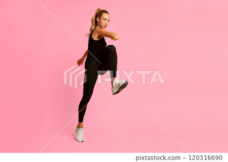 Fitness. Serious Sporty Woman Jumping Exercising In Studio Over Yellow Background. Full Length 120316690