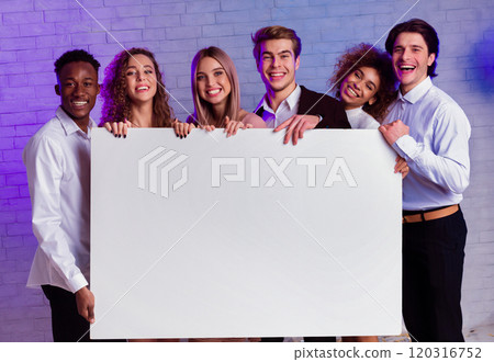 Multiracial Young People Holding Blank Poster For Text Advertising Something Standing Indoors. Corporate Party Invitation. Mockup 120316752