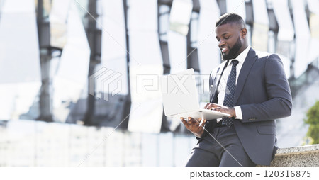 Happy African American Entrepreneur Using Laptop Browsing Internet During Coffee Break Outdoors In Urban City Area Happy African American Entrepreneur Using Laptop Browsing Internet During Coffee Break Outdoors In Urban City Area 120316875