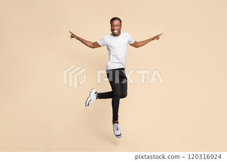 Cheerful Black Guy Jumping In Air Having Fun Posing Over Yellow Background. Studio Shot Cheerful Black Guy Jumping In Air Having Fun Posing Over Yellow Background. Studio Shot 120316924