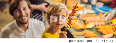 Dad and son are tourists on Walking street Asian food market BANNER, LONG FORMAT Dad and son are tourists on Walking street Asian food market BANNER, LONG FORMAT 120316954
