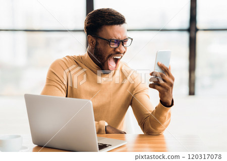 Stress Concept. Angry black businessman yelling at mobile phone at work, free space 120317078