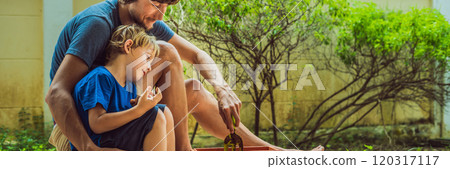 Father and son gardening in the garden near the house BANNER, LONG FORMAT 120317117