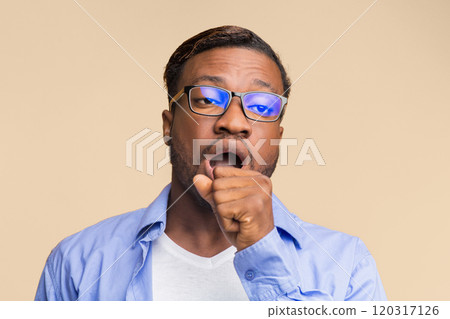Boredom. Sleepy Afro Man Yawning Covering Mouth With Hand Standing Over Yellow Background. Studio Shot Boredom. Sleepy Afro Man Yawning Covering Mouth With Hand Standing Over Yellow Background. Studio Shot 120317126