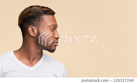 Profile Portrait Of African American Man Standing Over Yellow Studio Background. Panorama, Side View, Copy Space Profile Portrait Of African American Man Standing Over Yellow Studio Background. Panorama, Side View, Copy Space 120317248