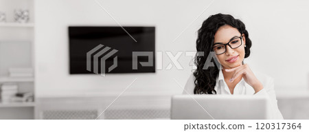 Business Career. Smiling pensive mexican woman using laptop computer sitting in modern office, copy space Business Career. Smiling pensive mexican woman using laptop computer sitting in modern office, copy space 120317364