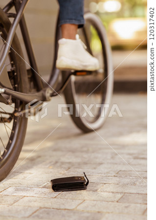 Daylife Troubles. Man Dropped His Wallet While Riding Bike Outdoors, Lost Money, Cropped Image 120317402