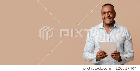 Mature african businessman holding digital tablet and smiling, orange studio background Mature african businessman holding digital tablet and smiling, orange studio background 120317404