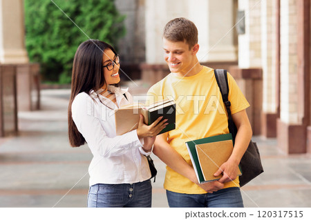 Students resting in university campus, studying with books outdoors, panorama 120317515