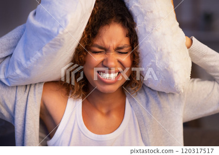 Angry student girl trying to sleep, covering ears with pillows and closing eyes, irritated with annoying sound Angry student girl trying to sleep, covering ears with pillows and closing eyes, irritated with annoying sound 120317517