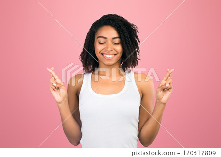 I Want To Win. Dreamy black girl raising her crossed fingers, making wish, free space I Want To Win. Dreamy black girl raising her crossed fingers, making wish, free space 120317809