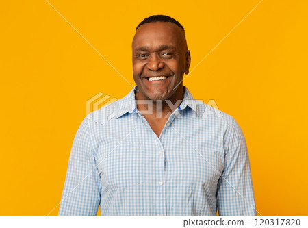 Portrait of middle aged african american man with happy smile, orange background Portrait of middle aged african american man with happy smile, orange background 120317820