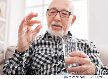 Old man taking pills with water glass. Healthcare, treatment, aging concept Old man taking pills with water glass. Healthcare, treatment, aging concept 120317952