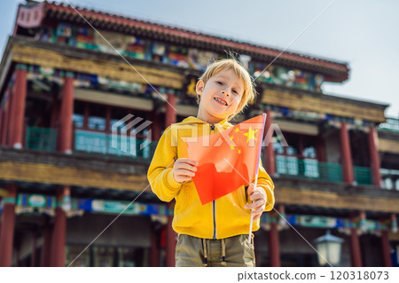 Enjoying vacation in China. Young boy with national chinese flag on the background of the old Chinese street. Travel to China concept. Visa free transit 72 hours, 144 hours in China 120318073