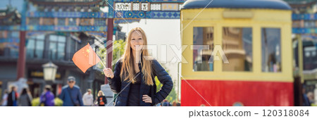 Enjoying vacation in China. Young woman with national chinese flag on the background of the old Chinese street. Travel to China concept. Visa free transit 72 hours, 144 hours in China BANNER, LONG Enjoying vacation in China. Young woman with national chinese flag on the background of the old Chinese street. Travel to China concept. Visa free transit 72 hours, 144 hours in China BANNER, LONG 120318084
