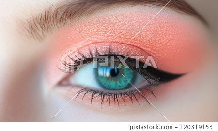 A stunning close-up reveals a well-defined eye adorned with coral eyeshadow and striking black eyeliner 120319153