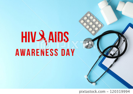 AIDS day, medicines and medical equipment on a blue background with text top view AIDS day, medicines and medical equipment on a blue background with text top view 120319994