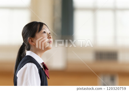 Japanese female student looking up in the gym Japanese female student looking up in the gym 120320759