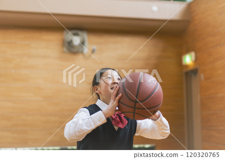 Female students playing basketball in the school gym 120320765