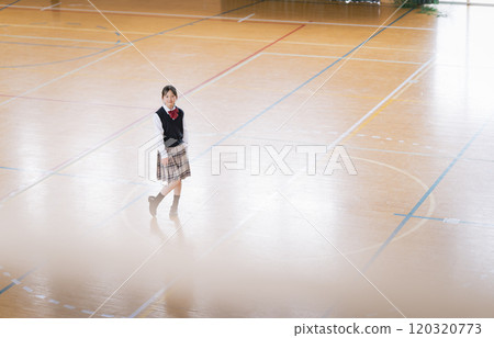 A black-haired Japanese female student in a gym A black-haired Japanese female student in a gym 120320773