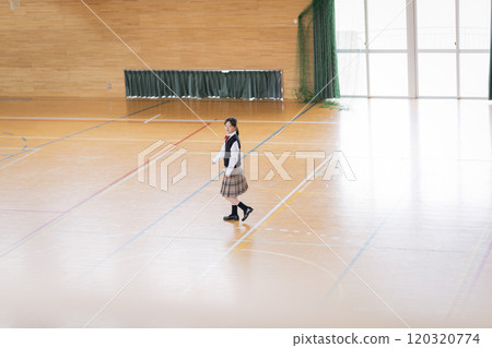 A black-haired Japanese female student in a gym A black-haired Japanese female student in a gym 120320774