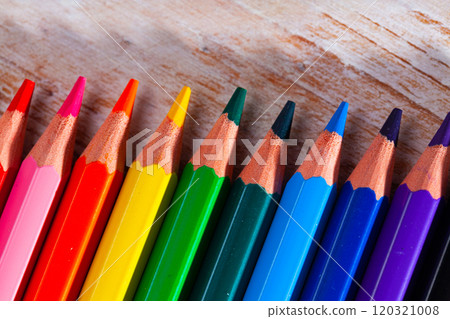 Set of multicolored pencils on wooden surface Set of multicolored pencils on wooden surface 120321008