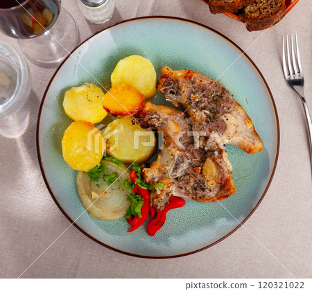 Roasted lamb leg with potatoes and stewed pepper fresh oven cooked closeup 120321022